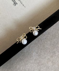 Trendy Hollowed-Out Bow Imitation Pearl Stud Earrings for Women - 2025 High-End Light Luxury Ear Accessories